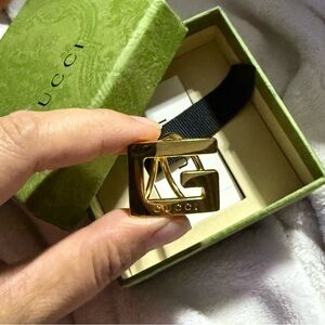 Gold metal Gucci scarf ring with logo at front